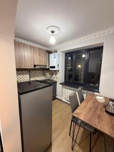 a kitchen and dining room with a table and a refrigerator at Terrace house Jermuk in Jermuk