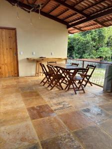 a patio with a wooden table and chairs at Casa Girasol in Trairi