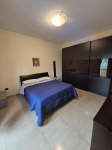 a bedroom with a large bed with a blue blanket at Casa Moschetti in Capodrise +58 photos