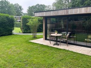 a gazebo with a table and chairs in a yard at maison Clavita in Genk