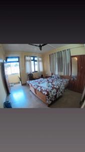 a bedroom with a large bed in a room at Hotel Pelican in Kalimpong