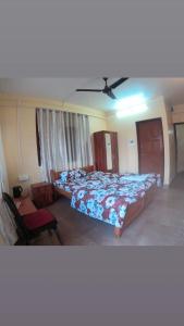 a bedroom with two beds and a ceiling fan at Hotel Pelican in Kalimpong