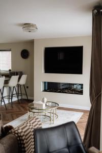 a living room with a couch and a fireplace at MD Stays in Portstewart