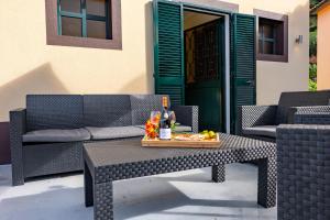 a table with a bottle of wine and a tray of fruit at View to the Valley, By OP in Senhora do Rosário