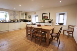 a kitchen and dining room with a wooden table and chairs at Relugas Mill in Forres