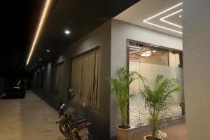 a motorcycle parked next to a building with plants at Hotel Hill Park in Indore