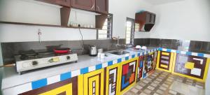 a kitchen with a lego inspired counter top at Johns Villa in Sultan Bathery