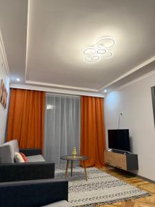 a living room with a couch and a tv at Terrace house Jermuk in Jermuk