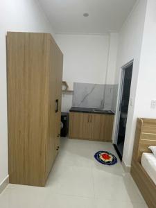 a room with a bed and a cabinet and a plate on the floor at LAKSHMI Apartment & Hotel Da Nang in Danang