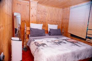 a bedroom with a bed in a wooden room at Falcon Lodge Bela Bela in Bela-Bela +11 photos