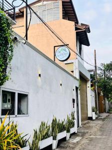 a building with a clock on the side of it at Zeleny Apartments in Nugegoda
