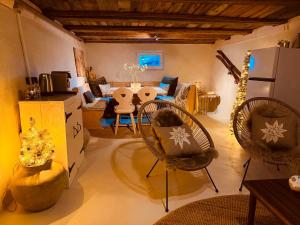 a living room with two chairs and a table at Lodge Rose's Heart in Bramberg am Wildkogel
