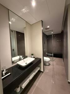 a bathroom with a sink and a toilet and a mirror at Rafa Hotel Apart in Riyadh +18 photos