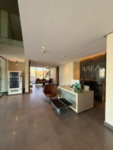 a lobby with a desk and a chair in a building at Rafa Hotel Apart in Riyadh