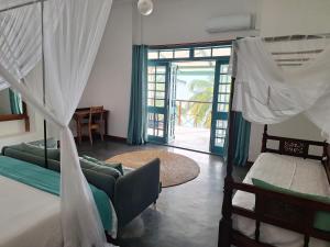 a bedroom with two beds and a living room at The Archipelago Waterfront in Zanzibar City