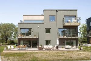 a large building with a patio and a table at The Oak - Ekerum Öland in Borgholm