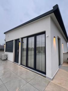 a white building with large glass doors on it at Emi Center Apartments in Gevgelija