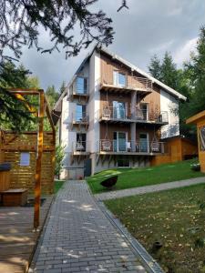 an apartment building with a brick walkway in front of it at U Gumisia in Korbielów