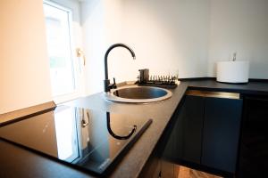 a kitchen counter with a sink and a window at Ghica Boutique Suites in Vaslui +67 photos