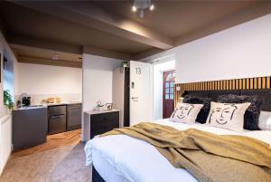 a bedroom with a bed with two faces on the pillows at The Coach House, Gatwick in Horley