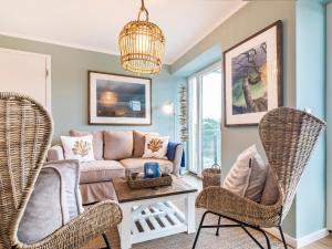 a living room with a couch and two chairs at Prora - Apartment mit Strandnähe - Aquarius in Binz