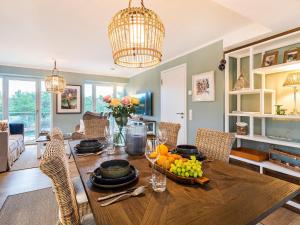 a dining room with a table with a bowl of fruit at Prora - Apartment mit Strandnähe - Aquarius in Binz +18 photos