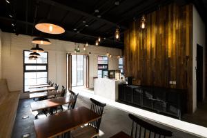 a restaurant with wooden tables and chairs and a bar at Yi Stack Hotel Beijing in Beijing