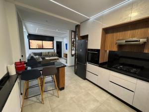 a kitchen with a table and chairs and a couch at Appartement sur villa in Temara