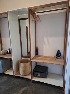 a room with wooden shelves and a mirror at The Archipelago Waterfront in Zanzibar City