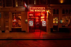 a building with a sign that reads st christoppers the winner at St Christopher's Amsterdam - The Winston in Amsterdam