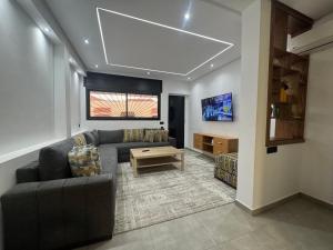 a living room with a couch and a table at Appartement sur villa in Temara