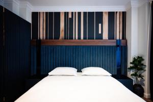 a bed with two white pillows in a bedroom at Ghica Boutique Suites in Vaslui