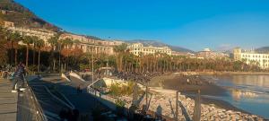 a group of people walking on a sidewalk next to a river at Nina in Love in Salerno