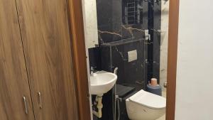 a bathroom with a sink and a toilet at Dream Inn in Bangalore +10 photos