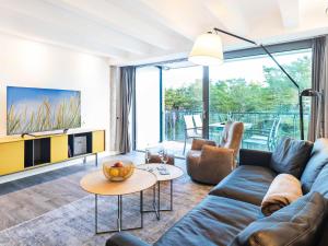 a living room with a couch and a table at Prora - Ferienwohnung mit Waschmaschine - Sunrise in Binz