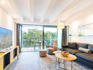 a living room with a couch and a table at Prora - Ferienwohnung mit Waschmaschine - Sunrise in Binz