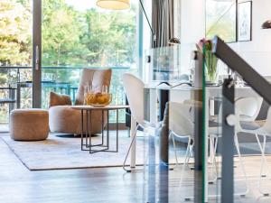 a living room with a table and chairs at Prora - Ferienwohnung mit Waschmaschine - Sunrise in Binz +14 photos