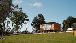 a house on a hill with a green field at Quinta Sra do Carmo in Ferreira do Zêzere