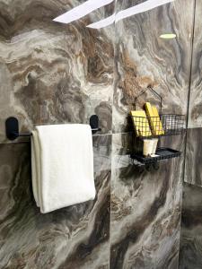 a bathroom with a towel rack and a towel at Bloom Hotel-Kuwait in Kuwait +25 photos