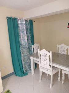 a dining room with a table and two chairs at Harmony Guest House in Bridgetown