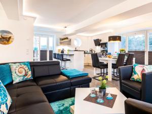 a living room with a couch and a table at Prora - Ferienwohnung mit Sauna - Meer geht immer in Binz