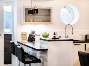 a kitchen with a black counter and a sink at Prora - Ferienwohnung mit Sauna - Meer geht immer in Binz