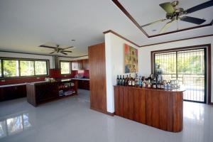 a kitchen with a bar with bottles of alcohol at Anapuro Elnido in El Nido
