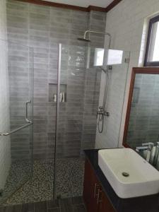 a bathroom with a shower and a sink at Anapuro Elnido in El Nido +2 photos
