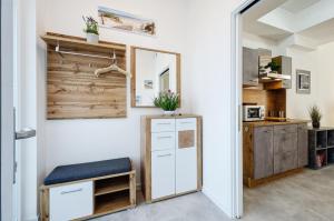 a kitchen with a white refrigerator and a mirror at Prora - Wohnung mit Terrasse - Proras Strandhaus in Binz