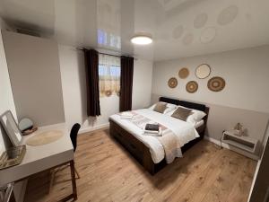 a bedroom with a bed and a table and a desk at JB apartments in Liptovský Mikuláš