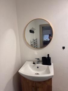 a bathroom with a sink and a mirror at JB apartments in Liptovský Mikuláš +26 photos