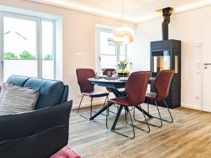 a kitchen and dining room with a table and chairs at Prora - Dachgeschoss Wohnung mit Sauna - Sky Lodge in Binz