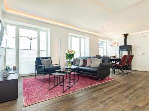 a living room with a couch and a table at Prora - Dachgeschoss Wohnung mit Sauna - Sky Lodge in Binz