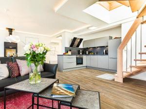 a living room with a couch and a table at Prora - Dachgeschoss Wohnung mit Sauna - Sky Lodge in Binz +17 photos
